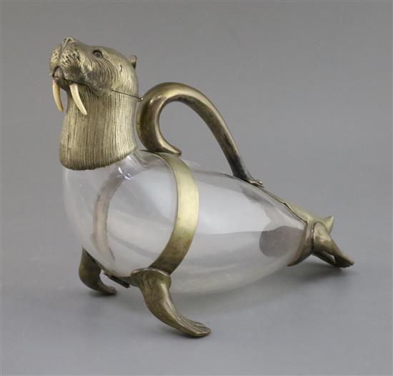 A Victorian novelty nickel mounted glass claret jug, modelled as a walrus, height 20.5cm.